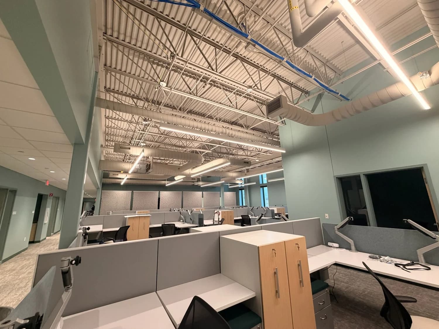 Open-plan offices with exposed ceilings at Foodbank for the Heartland in Omaha