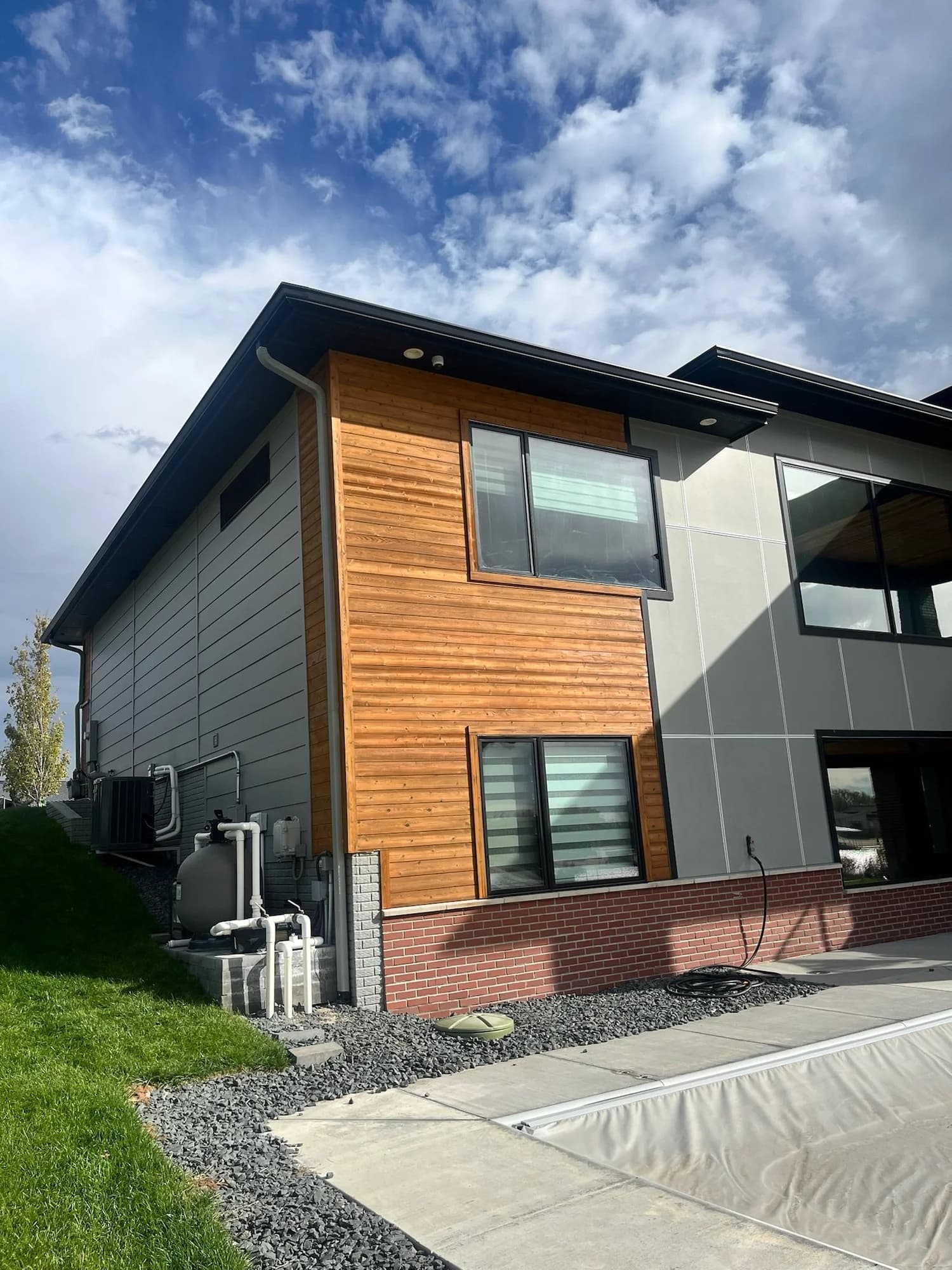 A modern exterior with stained cedar finished by DGR Painting Contractors